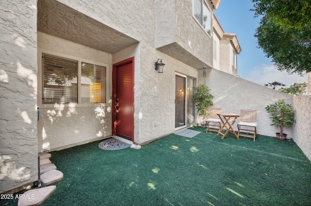 entrance to property featuring a yard