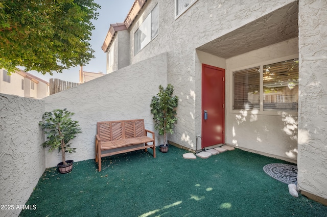 entrance to property with a lawn