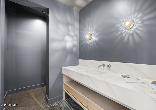 bathroom with vanity and baseboards