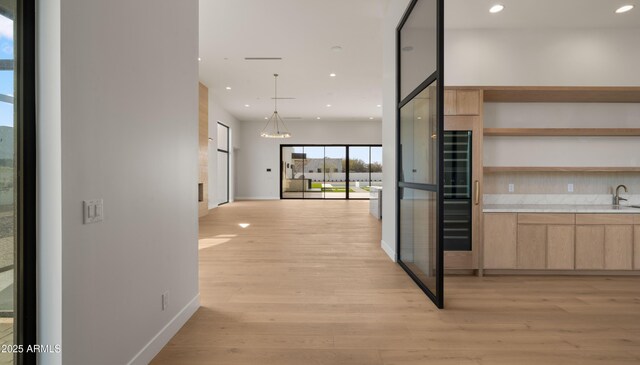 10220 N 66th St, Paradise Valley, AZ 85253 - hallway with baseboards, light wood-style flooring, recessed lighting, and a sink