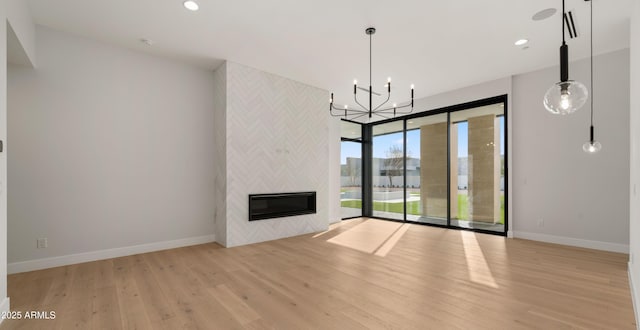 10220 N 66th St, Paradise Valley, AZ 85253 - unfurnished living room with baseboards, wood finished floors, recessed lighting, heating unit, and a notable chandelier