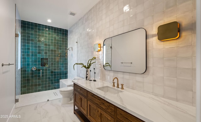 10220 N 66th St, Paradise Valley, AZ 85253 - full bath with marble finish floor, visible vents, a tile shower, and tile walls