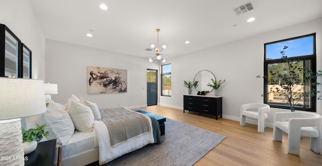 10220 N 66th St, Paradise Valley, AZ 85253 - bedroom featuring visible vents, baseboards, recessed lighting, light wood-type flooring, and an inviting chandelier