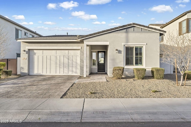 ranch-style home featuring a garage, driveway, and stucco siding