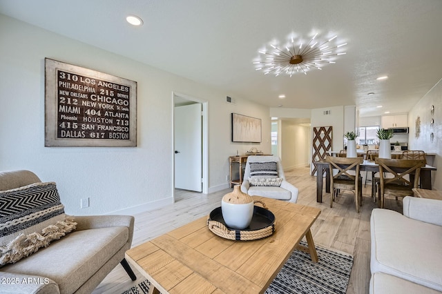 living area featuring recessed lighting, visible vents, light wood finished floors, and baseboards