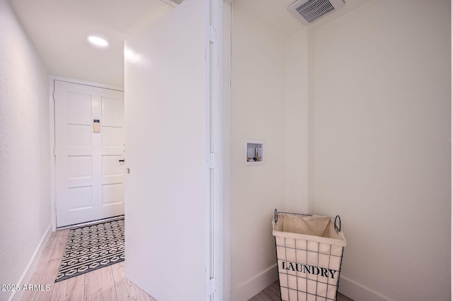 laundry room featuring hookup for a washing machine, wood finished floors, visible vents, baseboards, and laundry area