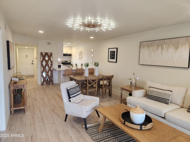 living room with recessed lighting, visible vents, a notable chandelier, and light wood finished floors