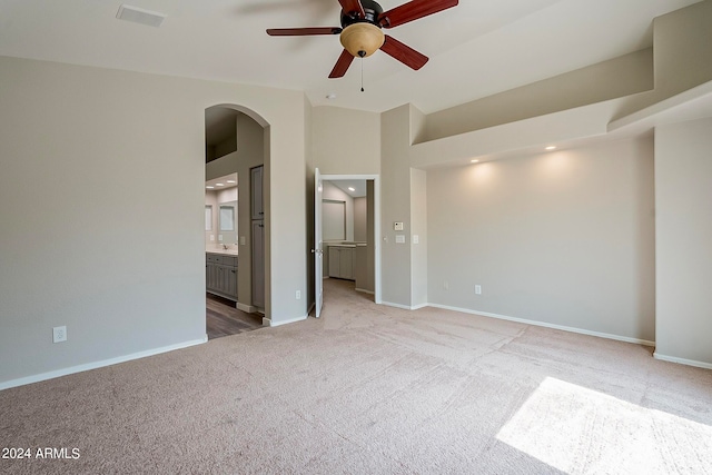 interior space with light carpet and ceiling fan