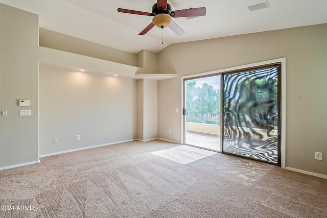 empty room with light carpet, vaulted ceiling, and ceiling fan