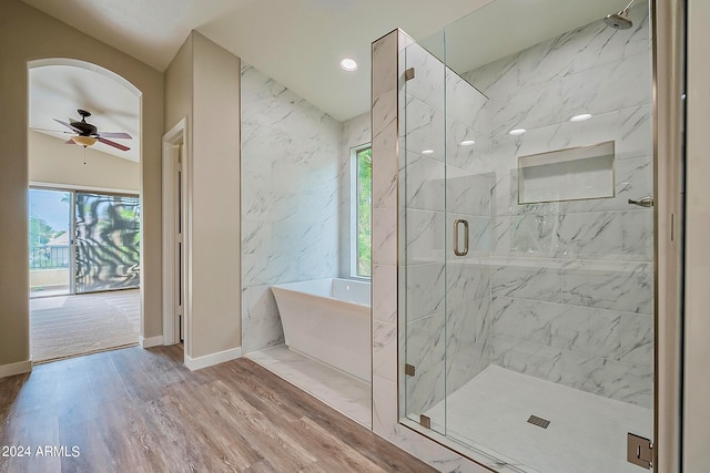 bathroom with wood-type flooring, vaulted ceiling, ceiling fan, and shower with separate bathtub