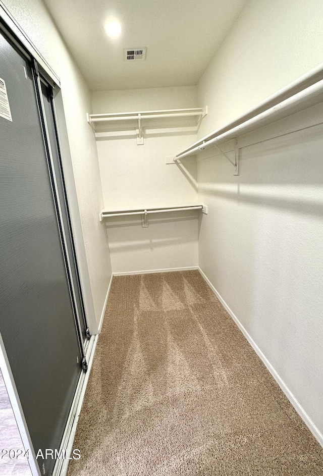 walk in closet with carpet floors and visible vents