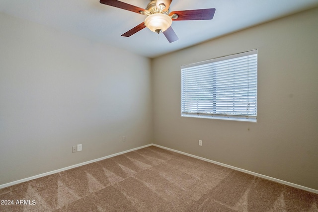 empty room with carpet floors, baseboards, and a ceiling fan