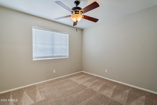 unfurnished room featuring baseboards, a ceiling fan, and light colored carpet