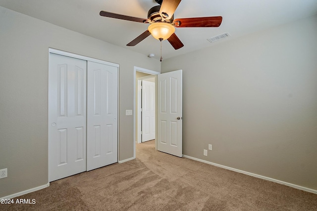 unfurnished bedroom with carpet floors, a closet, visible vents, and baseboards