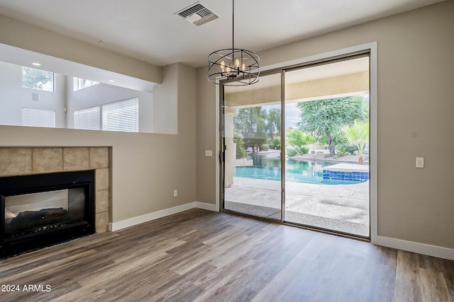 entryway with a healthy amount of sunlight, visible vents, baseboards, and wood finished floors