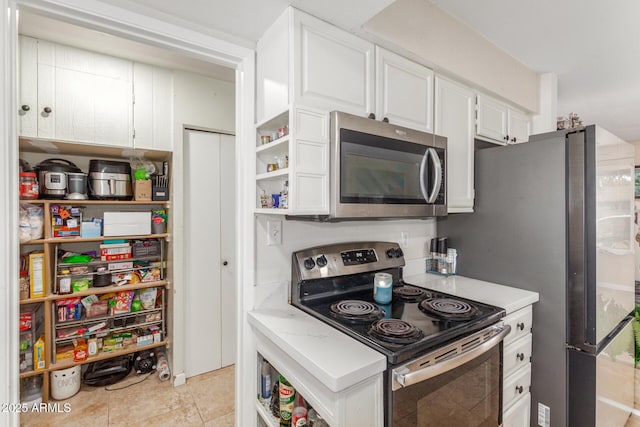 kitchen with white cabinetry and appliances with stainless steel finishes