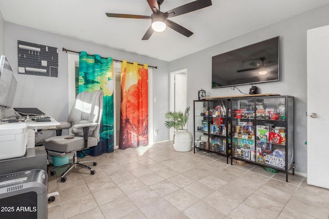 tiled office space featuring ceiling fan