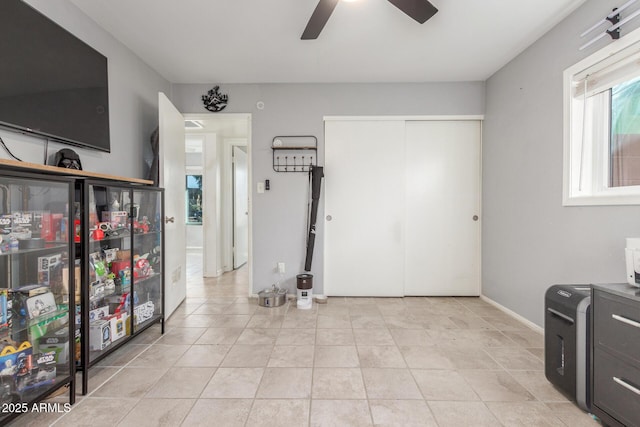 interior space featuring ceiling fan and light tile patterned flooring