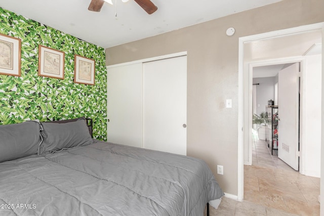 bedroom with ceiling fan and a closet