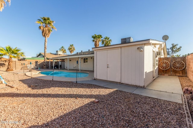 view of pool featuring central AC unit and a patio area