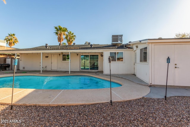 view of pool with a patio and central AC