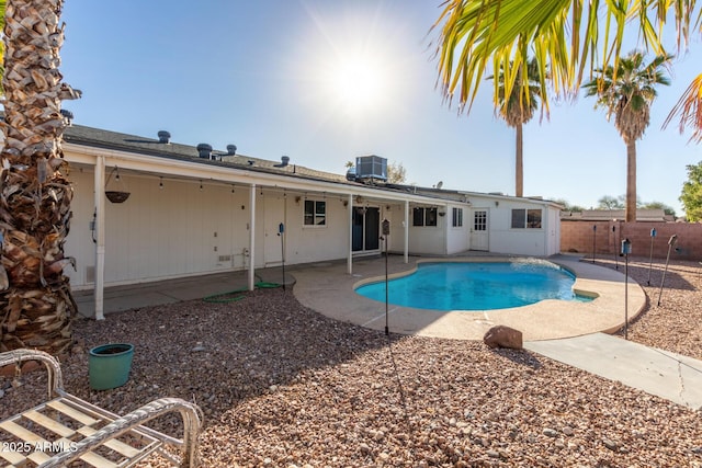 view of pool with cooling unit and a patio area