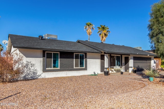 rear view of house featuring a garage