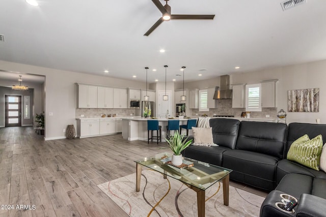 1557 E Flower St, Gilbert, AZ 85298 - living room featuring baseboards, recessed lighting, visible vents, and light wood-style floors