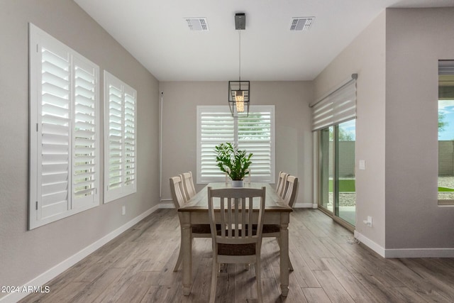 1557 E Flower St, Gilbert, AZ 85298 - dining space with baseboards, visible vents, and wood finished floors