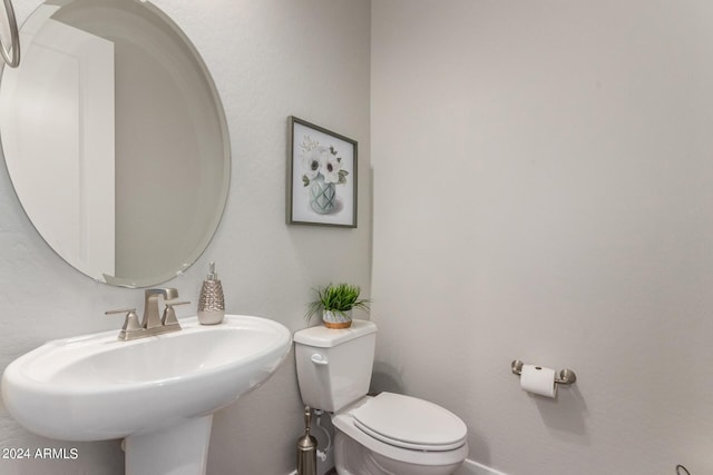 1557 E Flower St, Gilbert, AZ 85298 - half bathroom with baseboards, a sink, and toilet