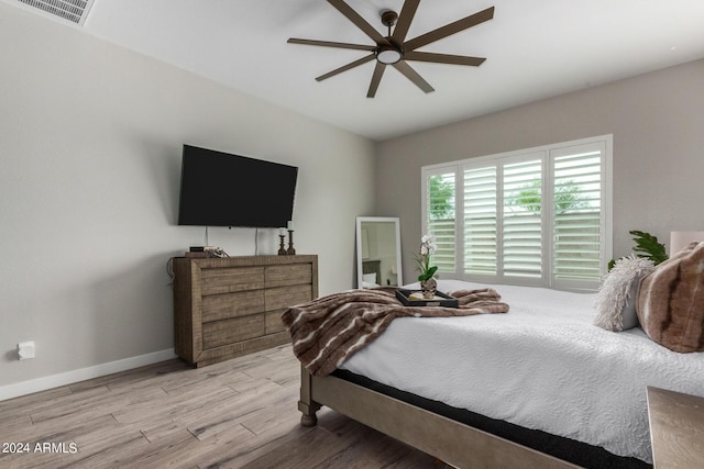 1557 E Flower St, Gilbert, AZ 85298 - bedroom with a ceiling fan, visible vents, baseboards, and wood finished floors