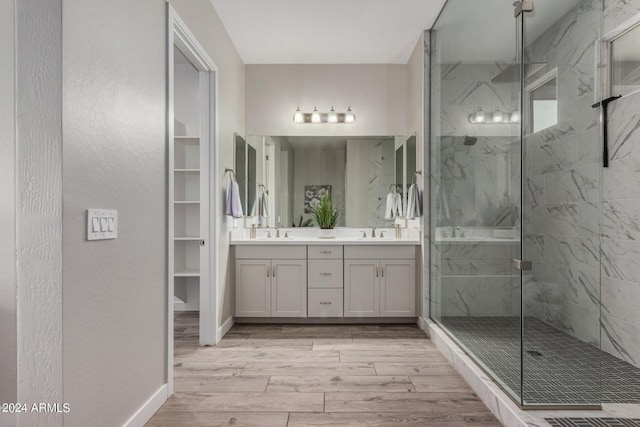 1557 E Flower St, Gilbert, AZ 85298 - full bathroom with double vanity, a sink, a marble finish shower, and wood finished floors