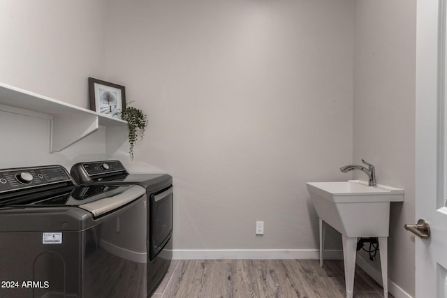 1557 E Flower St, Gilbert, AZ 85298 - washroom featuring light wood-type flooring, laundry area, baseboards, and independent washer and dryer