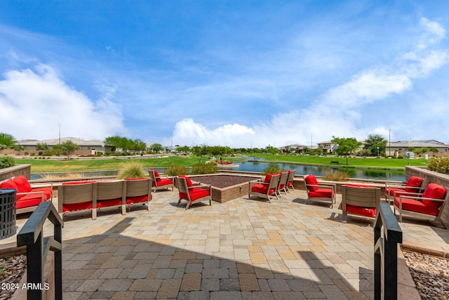 1557 E Flower St, Gilbert, AZ 85298 - view of patio / terrace featuring a water view and an outdoor living space with a fire pit