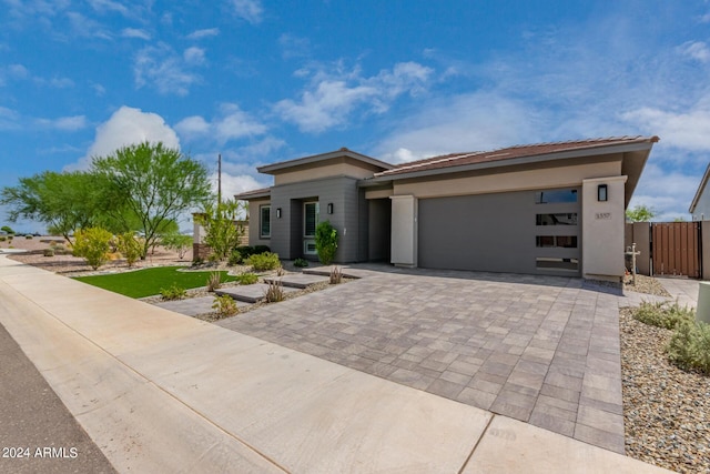 1557 E Flower St, Gilbert, AZ 85298 - prairie-style house with a garage, fence, and decorative driveway