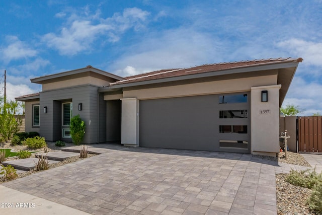 1557 E Flower St, Gilbert, AZ 85298 - prairie-style home featuring a garage, decorative driveway, and stucco siding