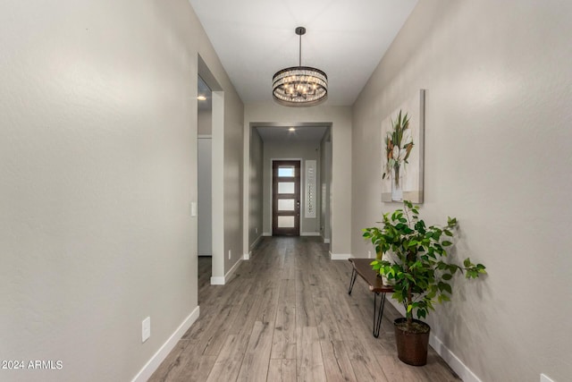 1557 E Flower St, Gilbert, AZ 85298 - interior space featuring a notable chandelier, light wood-style flooring, and baseboards