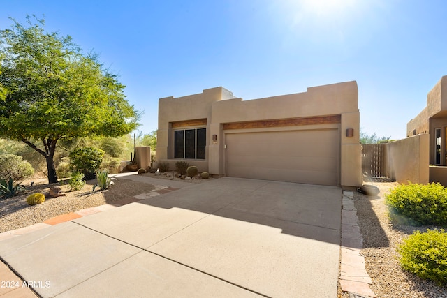 pueblo-style home with a garage