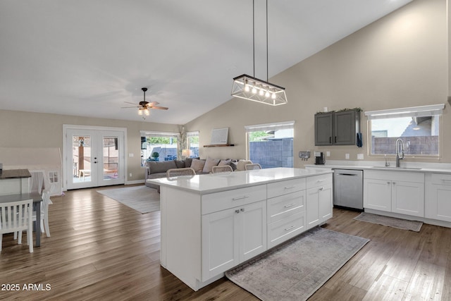 kitchen featuring white cabinetry, dishwasher, sink, and decorative light fixtures