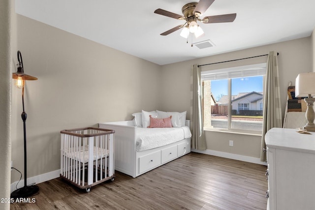 bedroom with ceiling fan and hardwood / wood-style floors