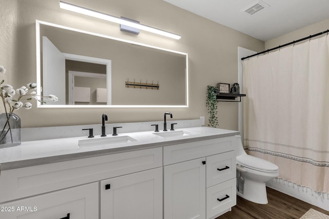 bathroom featuring vanity, hardwood / wood-style floors, curtained shower, and toilet