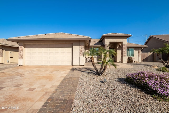 prairie-style house with driveway, a tile roof, a garage, and stucco siding