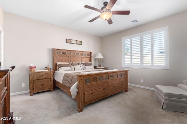 bedroom with visible vents, light carpet, and baseboards