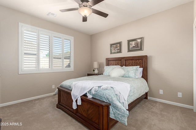 carpeted bedroom featuring ceiling fan, visible vents, and baseboards