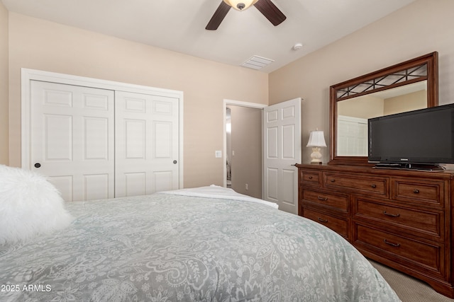 bedroom with a closet, visible vents, and ceiling fan