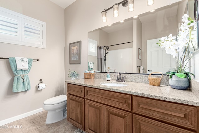 bathroom featuring toilet, vanity, baseboards, a shower, and tile patterned floors