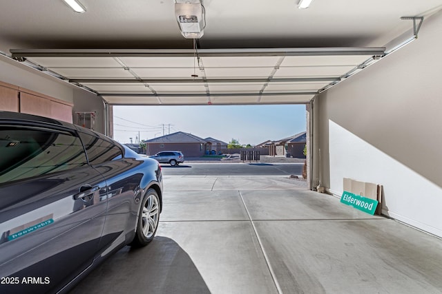 garage with a garage door opener and a residential view