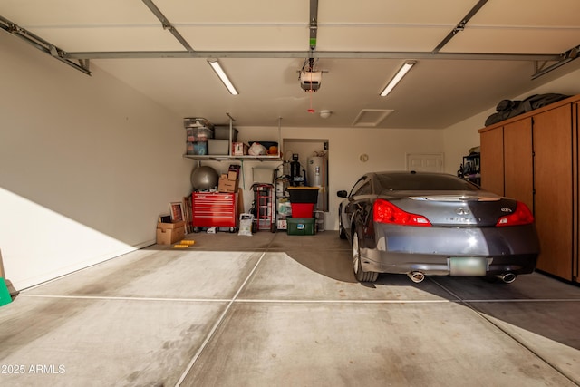 garage with electric water heater and a garage door opener