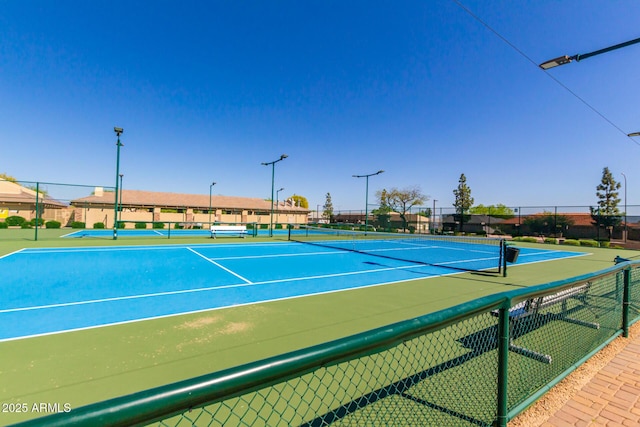 view of tennis court with fence