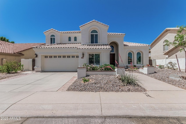 mediterranean / spanish-style house with stucco siding, fence, and a garage